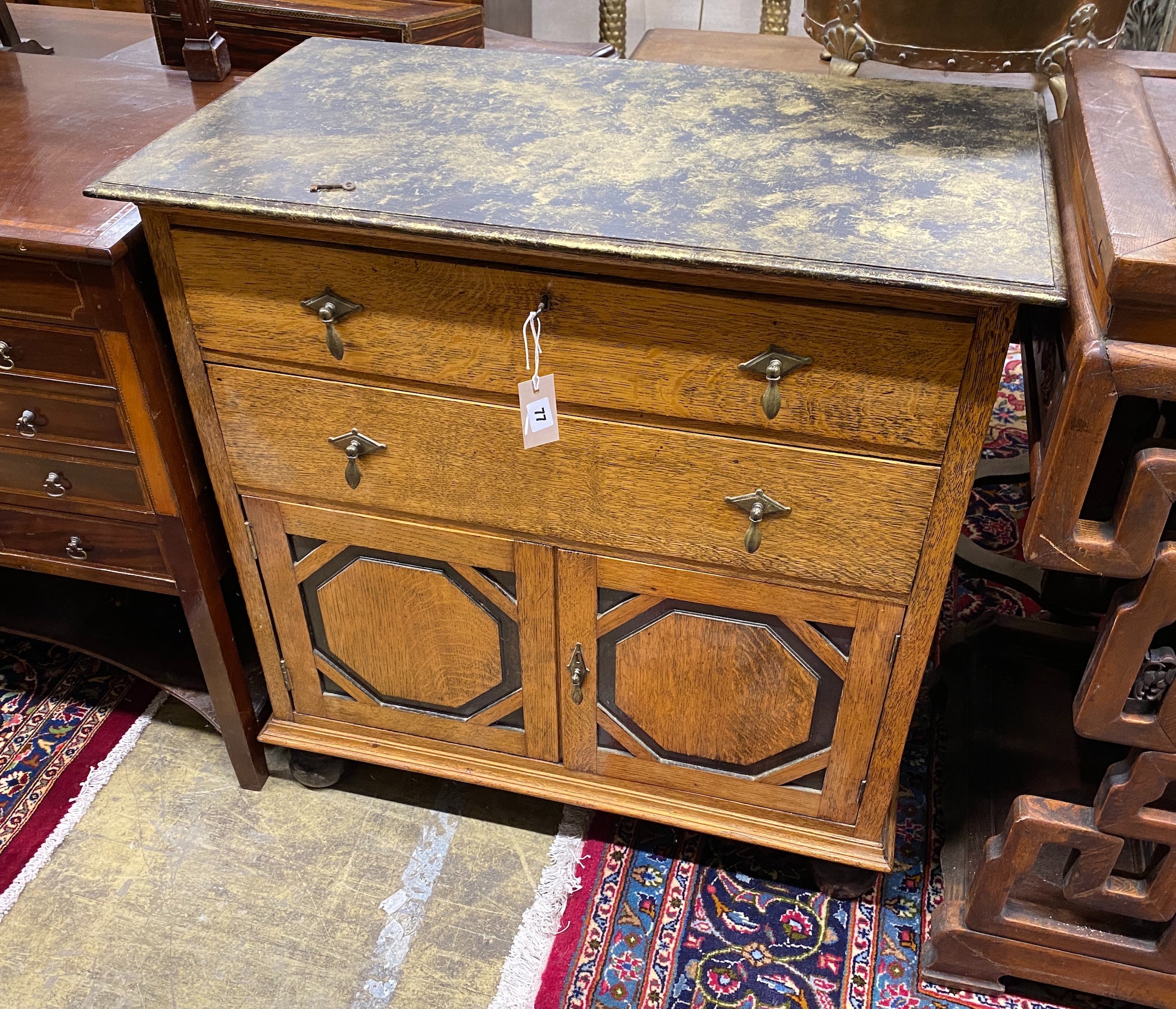 A 1920's oak side cabinet with painted faux marble top, width 83cm, depth 46cm, height 86cm